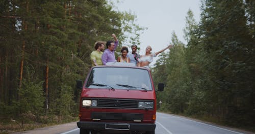 Group of Young People Travelling in Back of Pickup Truck