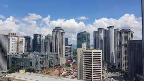 Time-Lapse Video of City Buildings Under White Clouds