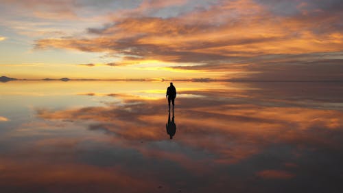 Drone Video of a Man Standing at a Sunset Point