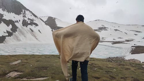 Man Walking on the Outdoors While Snowing