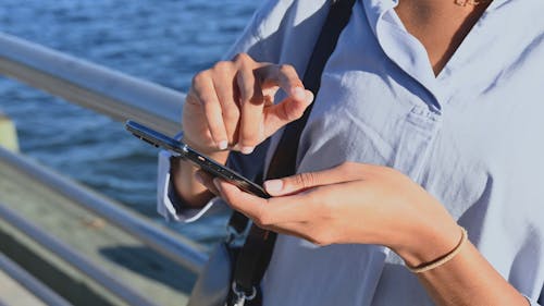 Close-Up View of a Person Using a Cellphone