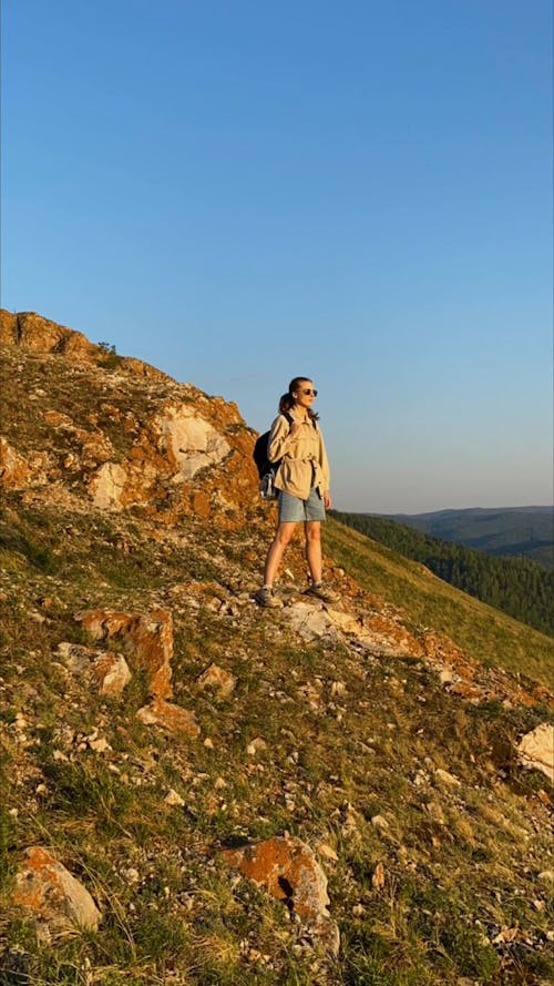 Woman Standing at a Mountain Slope