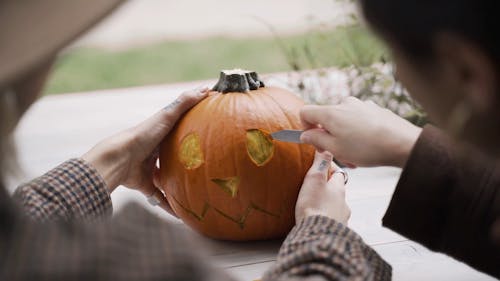 People Carving a Pumpkin