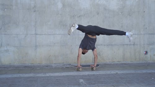 Man Doing Handstand on Skateboard