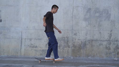 man Skateboarding at Street Pavement