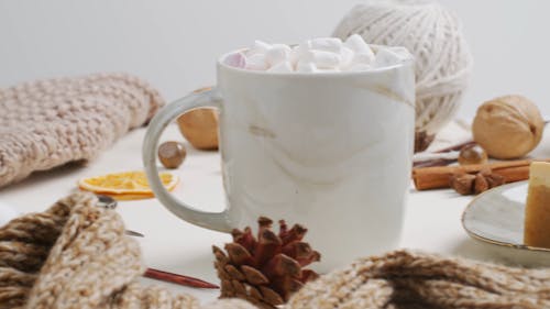 Cup of Marshmallow Placed between Flatlay Items