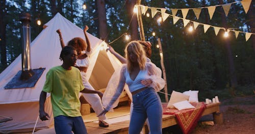 Young People Dancing in Camping Site