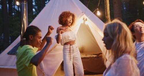 Young People Dancing in Camping Site