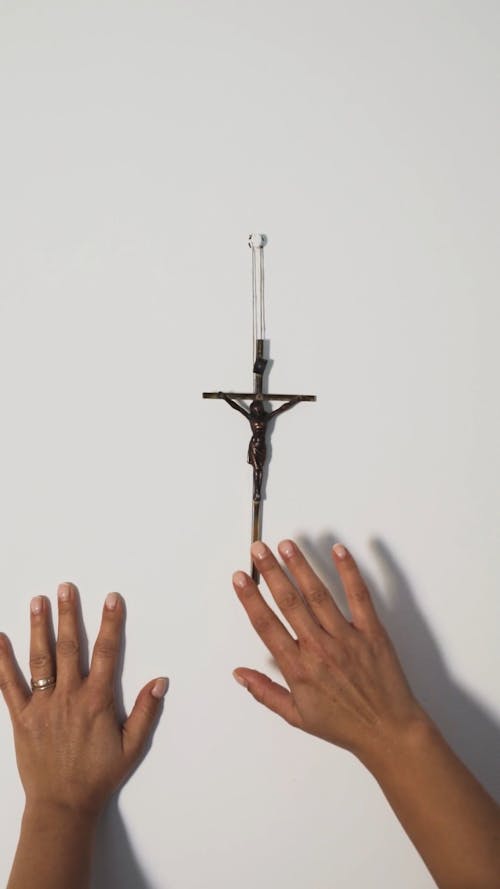 A Person Touching a Crucifix