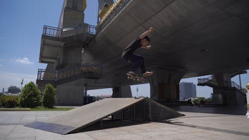 Skateboarder Doing a Trick on the Ramp