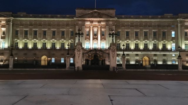 Night view of Buckingham Palace, lit up, in London.