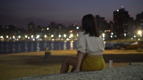 Shallow Focus of Woman Sitting Alone on a Concrete Floor