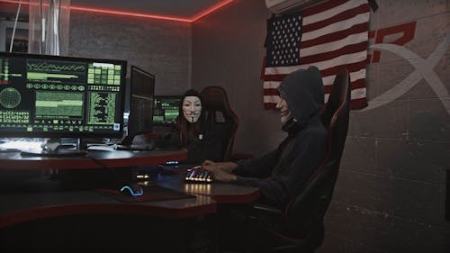 People Hacking the System while Wearing a Hacker Mask
