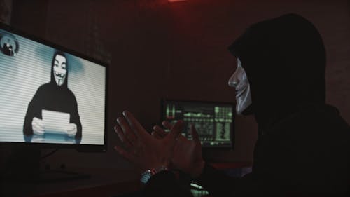 People in Masks Having a Conversation on a Video Call