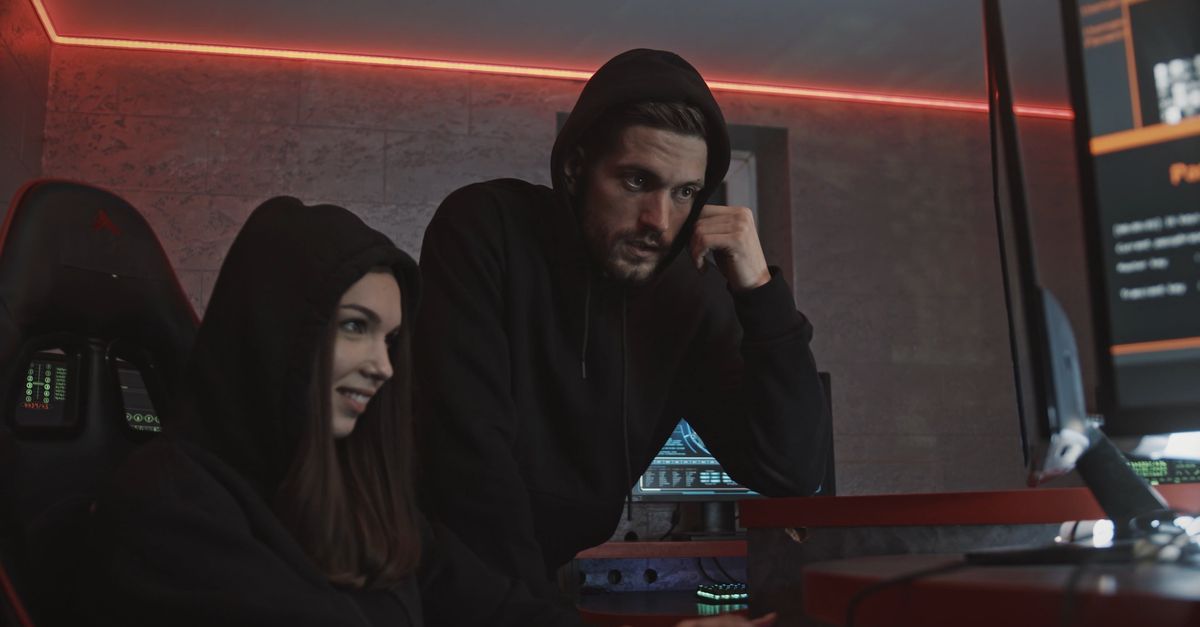 A Man Watching a Woman Type Codes on a Computer · Free Stock Video