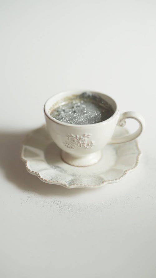 A Coffee Cup Sprinkled by Silver Glitters