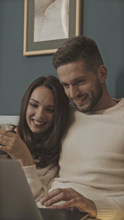 A Couple Watching Something From A Laptop