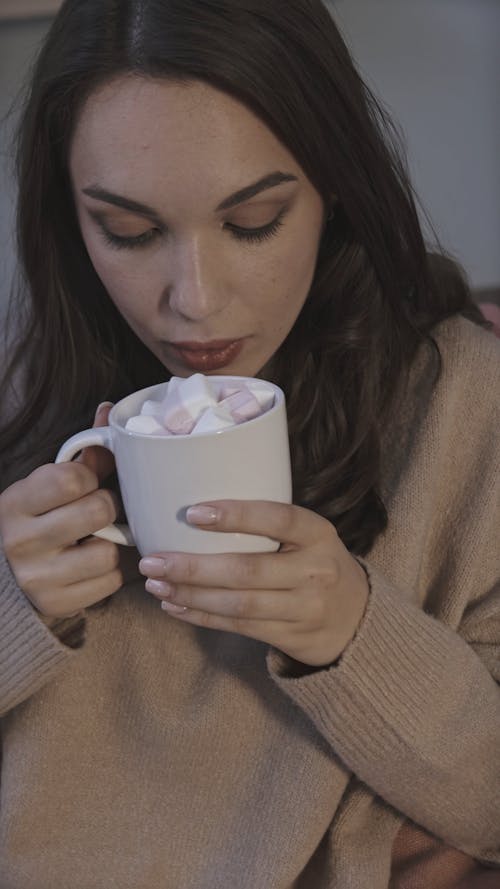 A Woman Drinking Hot Cocoa with Marshmallows