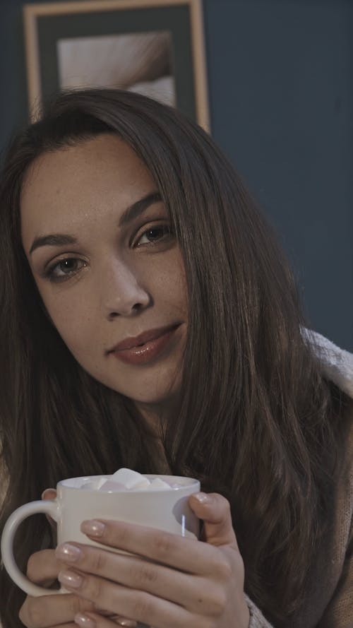 A Woman Drinking Hot Cocoa To Keep Warm