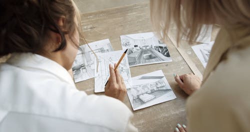 Two Women Looking At Home Interior Designs 