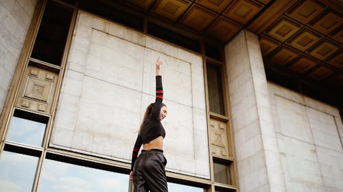 A Video Footage Of A Young Woman Dancing Outdoors