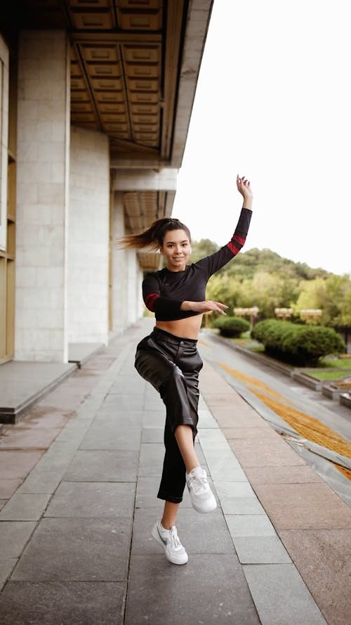 A Woman Showing Her Ballet Skill In Turning One Footed