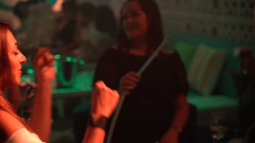 Women at Nightclub Smoking Hookah and Having Fun