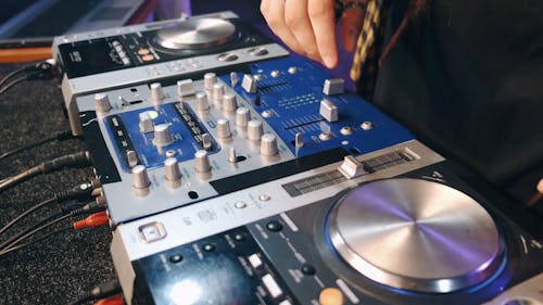A DJ Working On A Sound Mixer