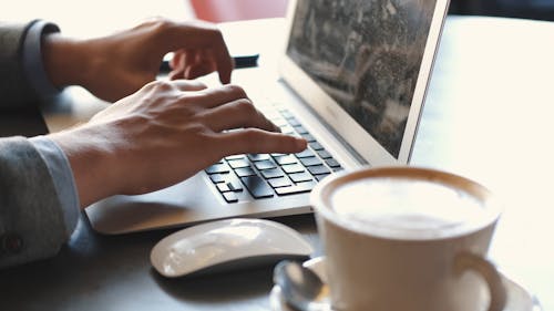 A Person Typing on a Laptop