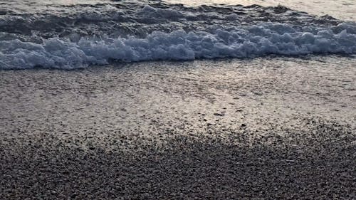 Waves Kissing the Shore Under a Golden Sky