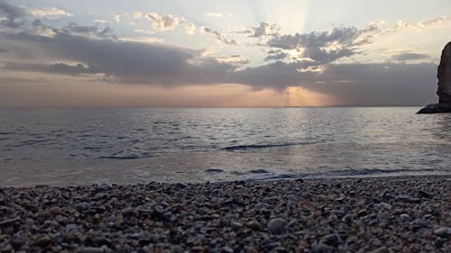 Waves Kissing the Shore Under a Golden Sky