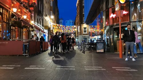 People Walking in The Streets of London at Night