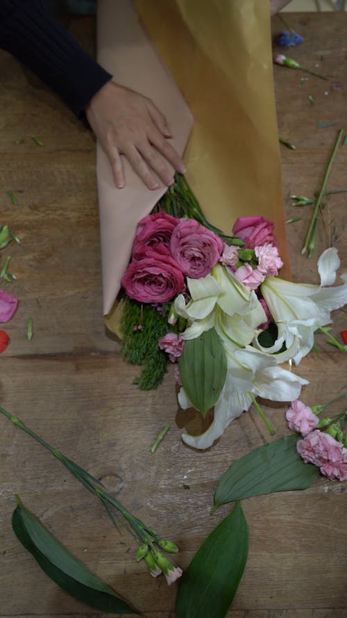 Person Arranging a Bouquet of Flowers