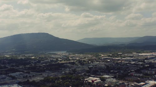 Drone Footage of a City by the Mountains