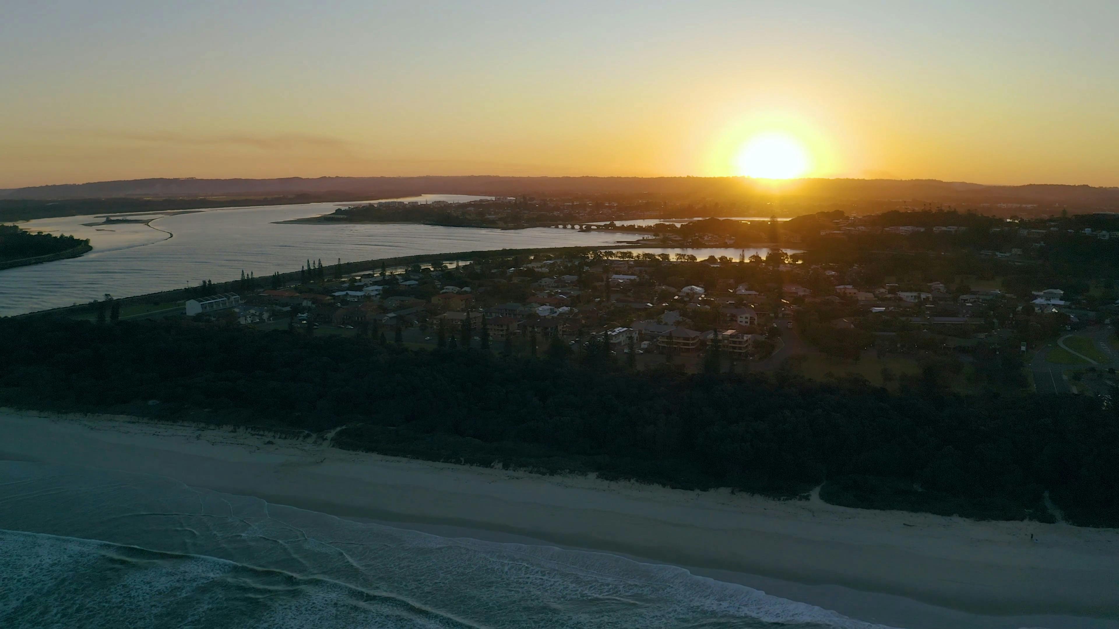 Aerial View of Seaside Town and Sunset Sky · Free Stock Video