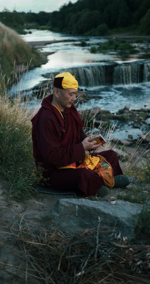 A Monk Holding a Prayer Beads and Book