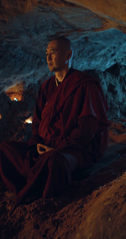 A Monk Meditating Inside a Cave