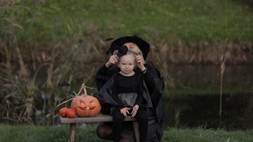 Mother and Daughter Wearing Halloween Costumes