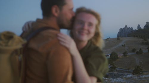 Young Couple Hugging and Kissing at Sunset 