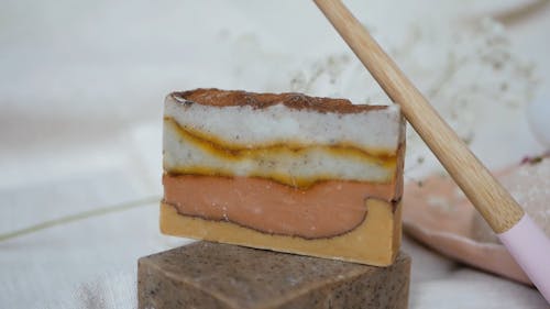 A Wooden Toothbrush and Bar Soaps