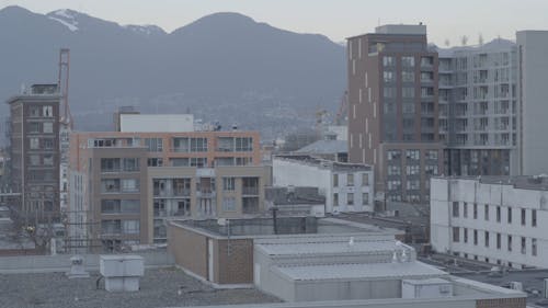 Still Video of City Buildings with Mountain Background
