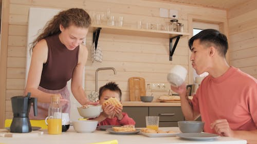 Little Boy Eating Breakfast with Parents