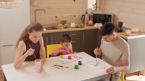 Parents Painting with Son in the Kitchen