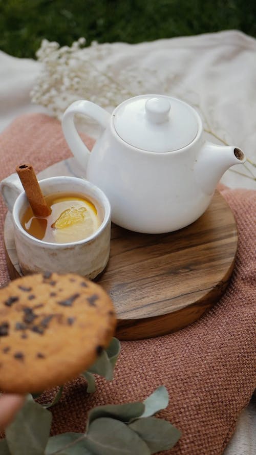 Placing chocolate chip cookie with Lemon Honey Tea