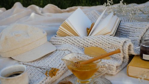 Flat lay Arrangement of Books, Sweaters and Candles