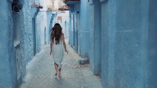 Woman Running on the Cozy Streets of Chefchaouen City