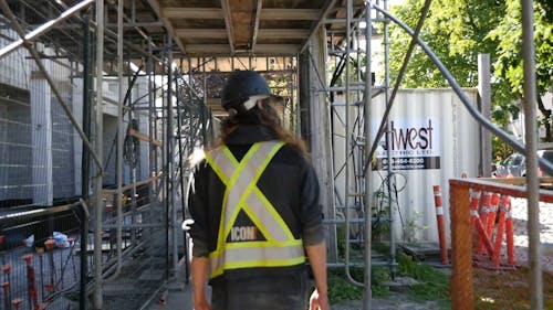 A Person Walking while Wearing a Hard Hat