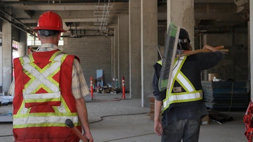 Workers Walking in Construction Site 