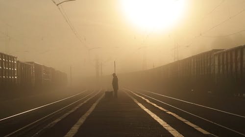 Person Standing in the Middle of a Railways