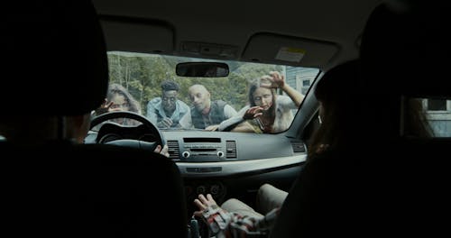 Zombies Attacking a Woman and a Boy Inside a Car
